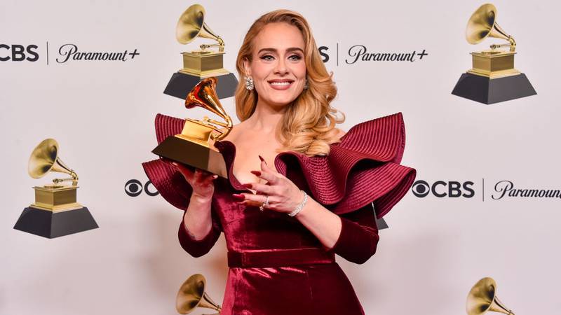 Adele holding a Grammy Award