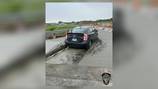Car stuck in wet concrete in construction zone in Clark County