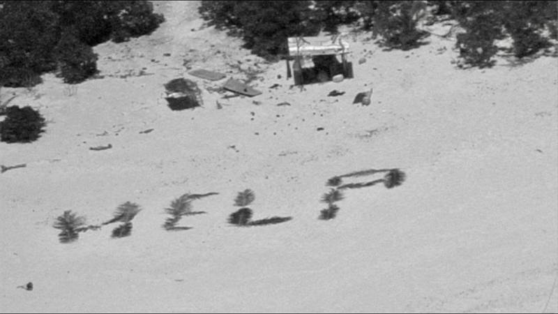 Help spelled out on beach