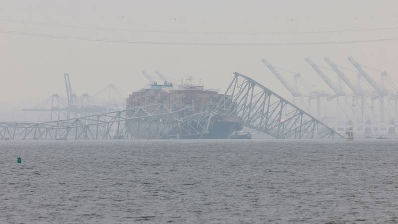 Cargo ship Dali under collapsed bridge.
