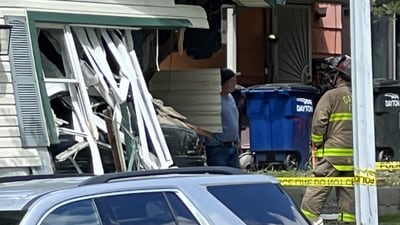 PHOTOS: Vehicle crashes through house in Dayton