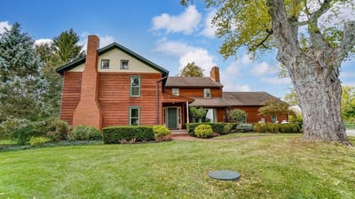 PHOTOS: Rustic log home with cathedral ceilings, garden house hits market for $924K