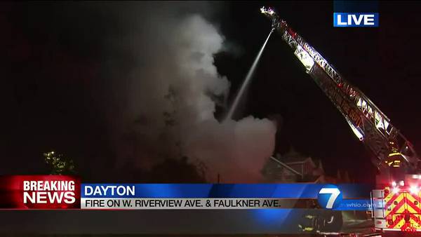 Crews work to put out house fire in Dayton