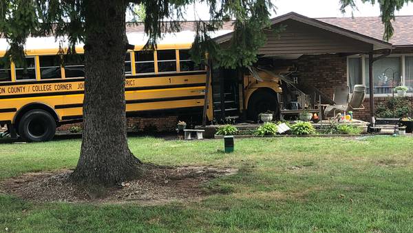 PHOTOS: School bus crashes into house in College Corner