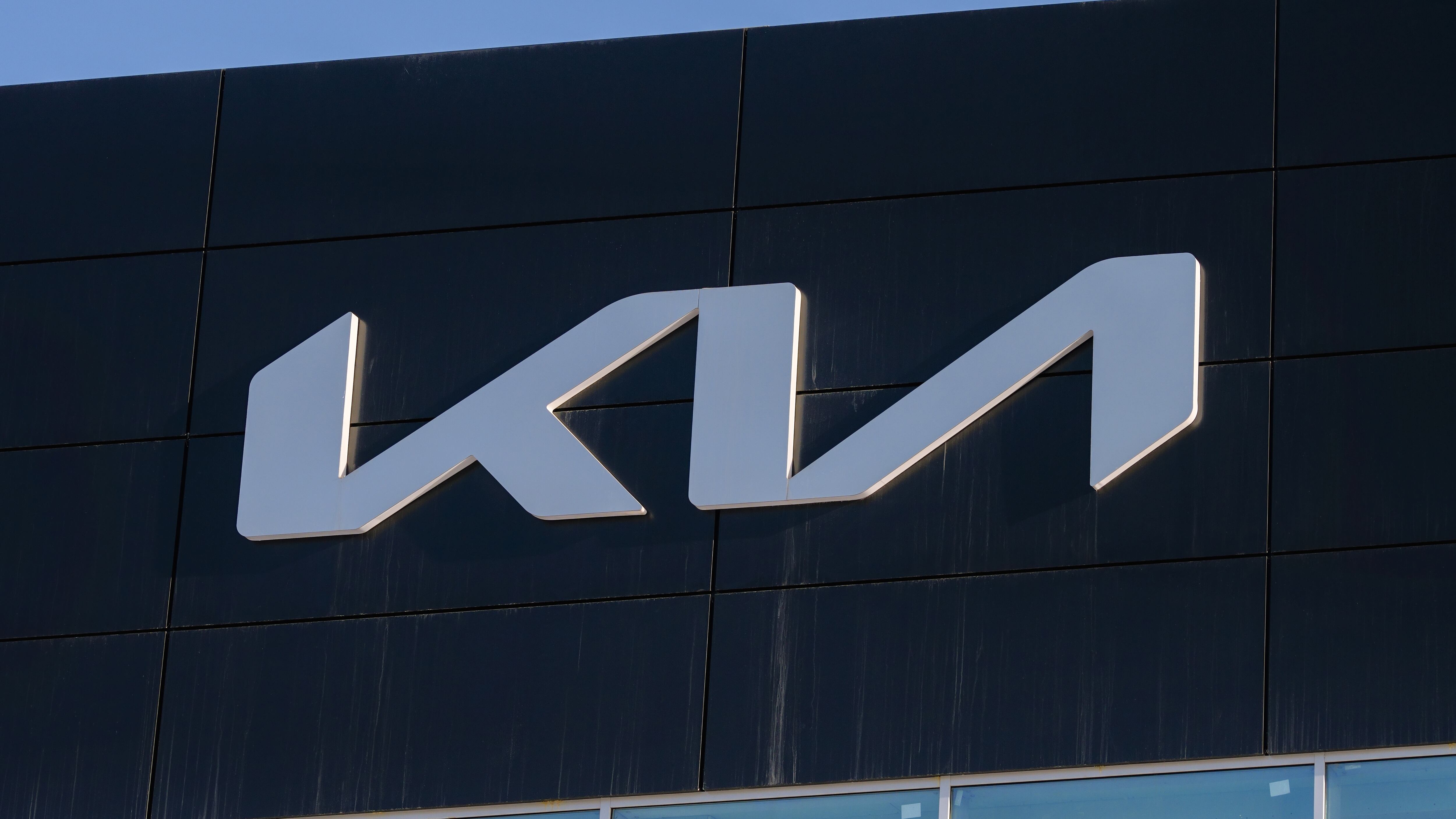 Kia logo on the facade of a car dealership