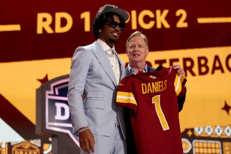 DETROIT, MICHIGAN - APRIL 25: Jayden Daniels poses with NFL Commissioner Roger Goodell after being selected second overall by the Washington Commanders during the first round of the 2024 NFL Draft at Campus Martius Park and Hart Plaza on April 25, 2024 in Detroit, Michigan. (Photo by Gregory Shamus/Getty Images)