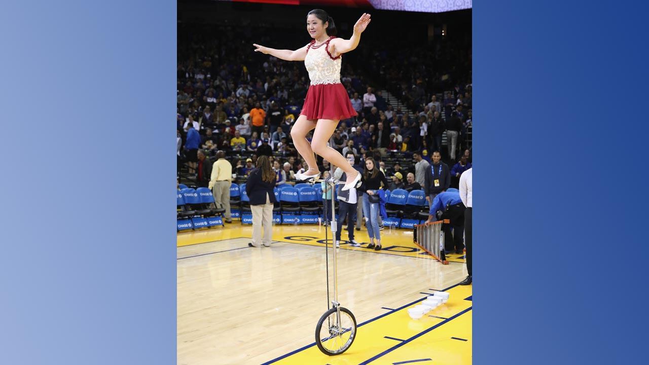 Rong Niu on a unicycle during a basketball game