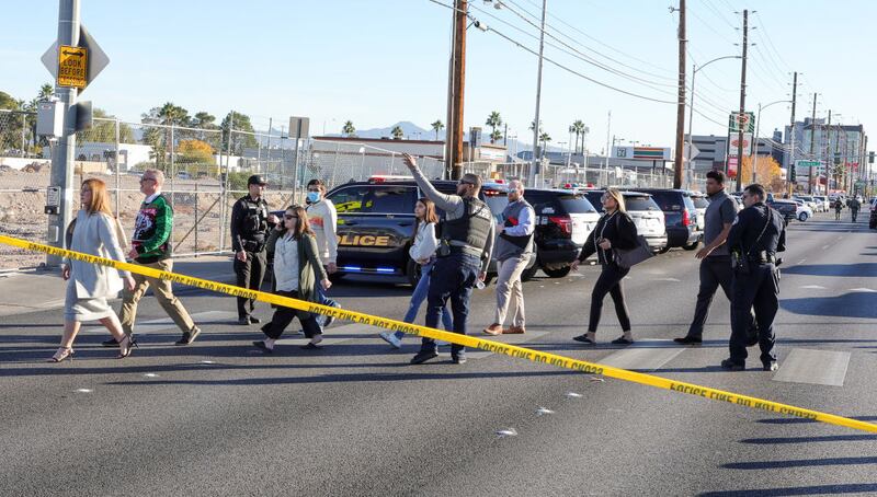 LAS VEGAS, NEVADA - DECEMBER 06: People cross Maryland Parkway as they are led off of the UNLV campus after a shooting on December 06, 2023 in Las Vegas, Nevada. According to Las Vegas Metro Police, a suspect is dead and multiple victims are reported after a shooting on the campus. (Photo by Ethan Miller/Getty Images)