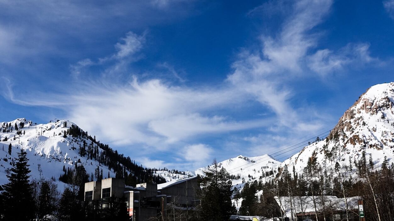 Peaks and lifts against a blur winter sky. Palisades Tahoe ski resort, California.