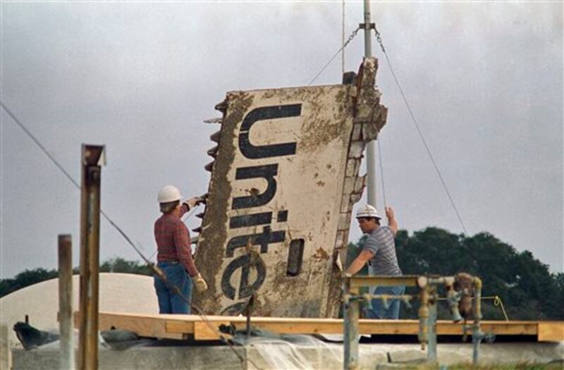 FILE - In this 1986 file photo, workers transport debris from the space shuttle Challenger, recovered after the Jan. 28, 1986 explosion, to a storage site on the Canaveral Air Force Station in Cape Canaveral, Fla. (AP Photo/James Neihouse)