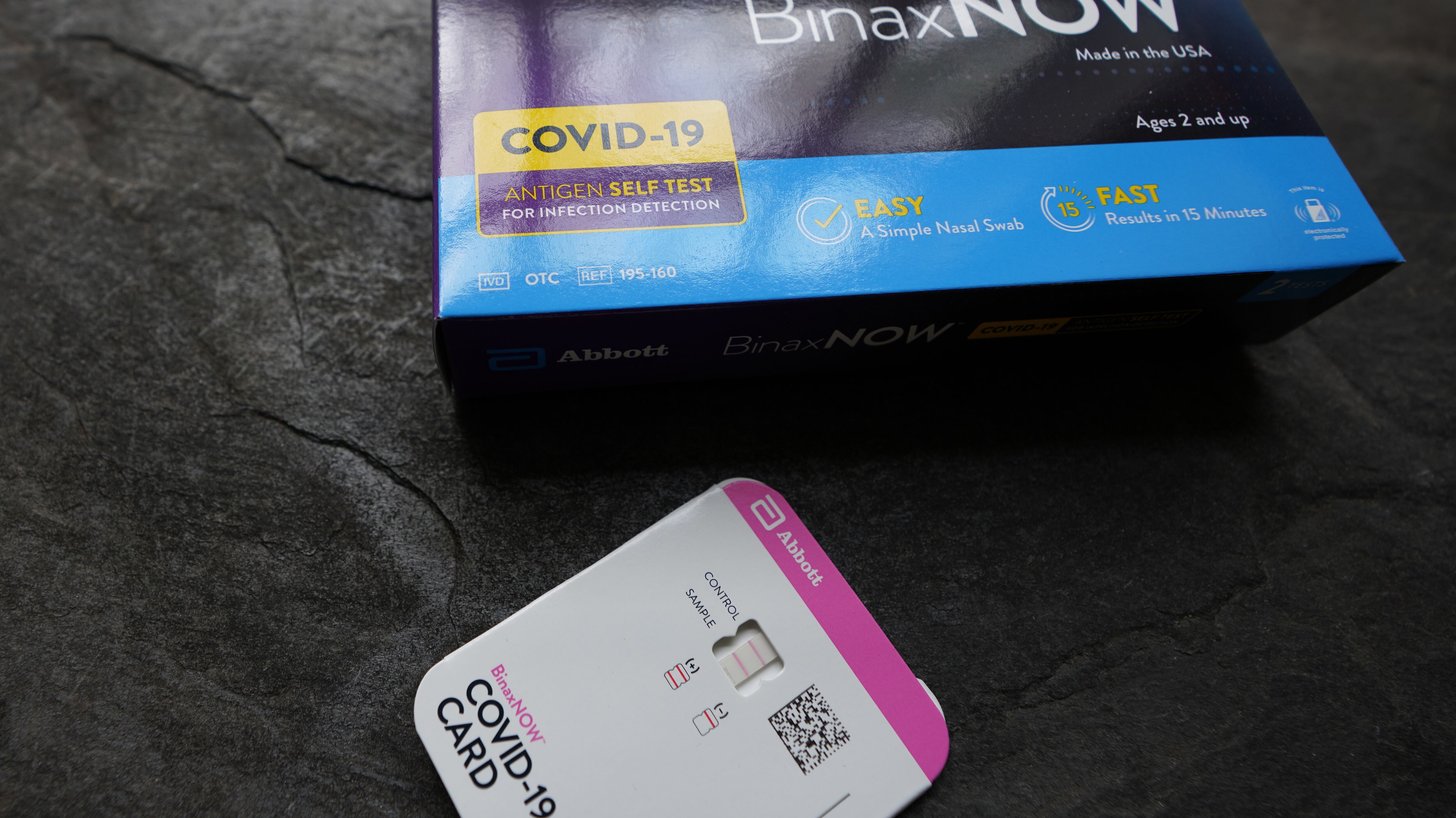Abbott BinaxNOW rapid covid test kit showing a positive result