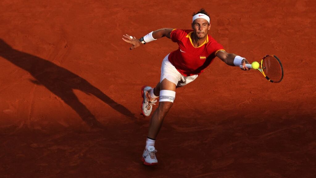 Rafael Nadal playing tennis at the Paris Olympics.