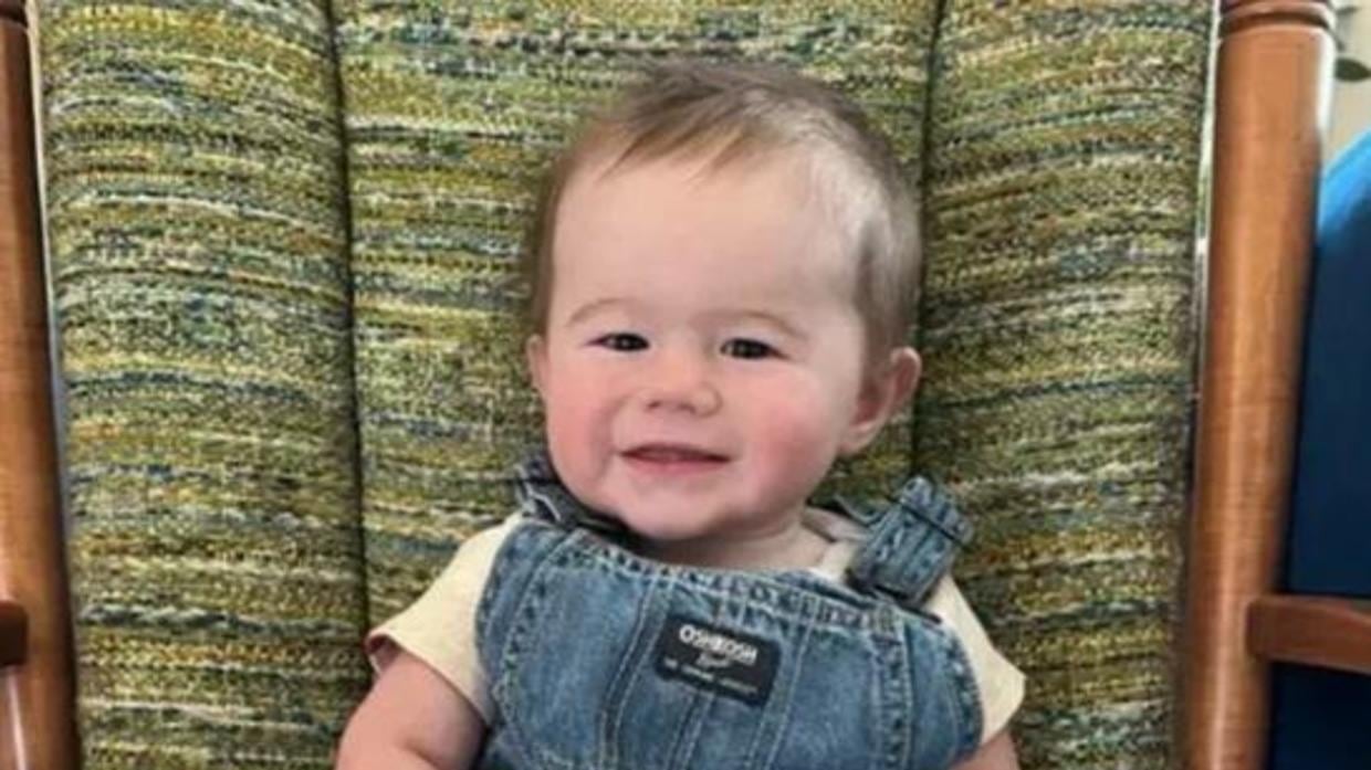 According to police, the baby’s father was taken into custody on a warrant in connection with the death of his pregnant wife.