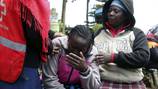 Kenyan officials remove bodies as they try to confirm the death toll from a school dormitory fire